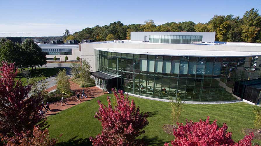 Image of modern building on bucolic college campus with fall foliage