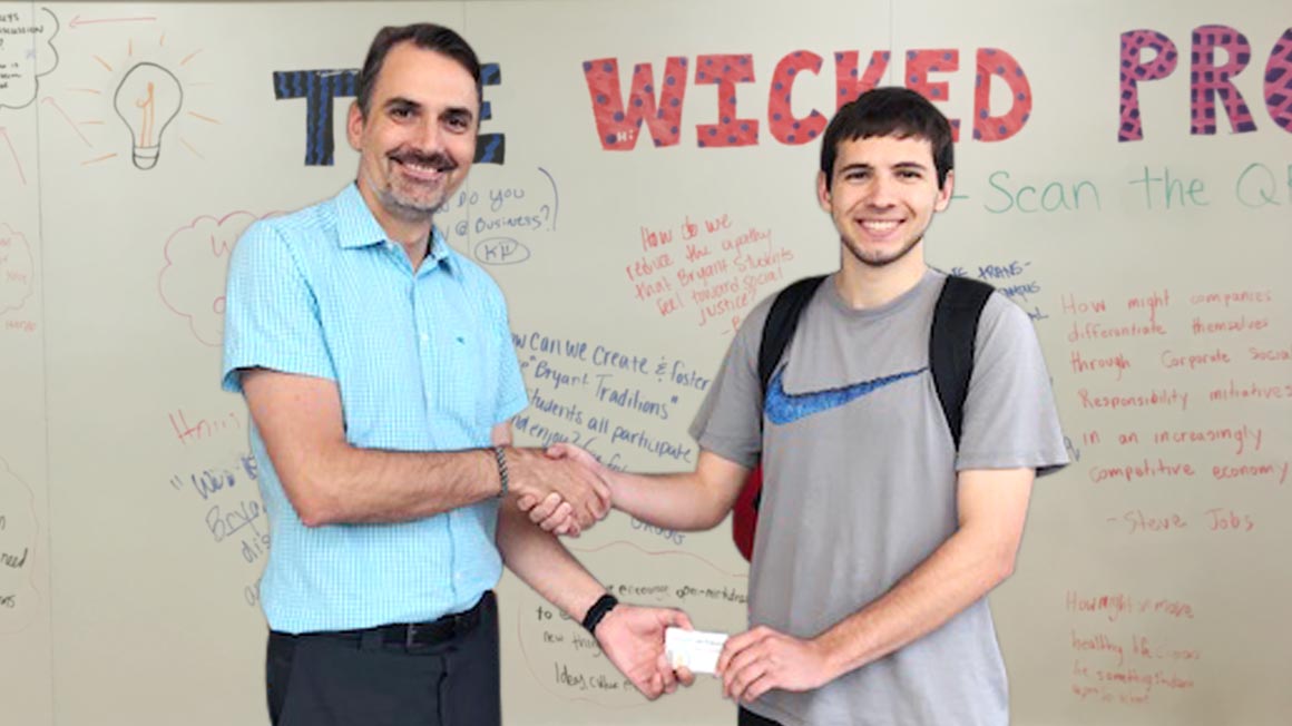 Professor Dirk Primus congratulates Nick Leitkowski '19, for his winning Wicked Problem. 