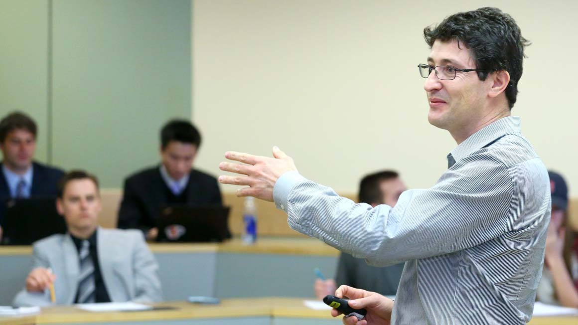 Professor of Economics Edinaldo Tebaldi, Ph.D, teaching a roomful of students at Bryant University
