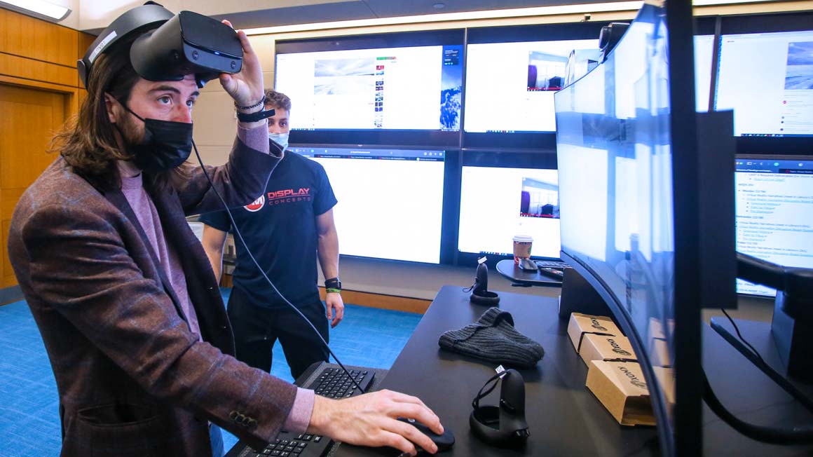 Professor Ryan Marnane adjusts a VR headset