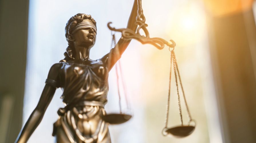 Lady Justice holding an imbalanced scale.