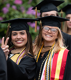     Two students pose for the camera during the 2023 Bryant University undergraduate commencement exercises.
