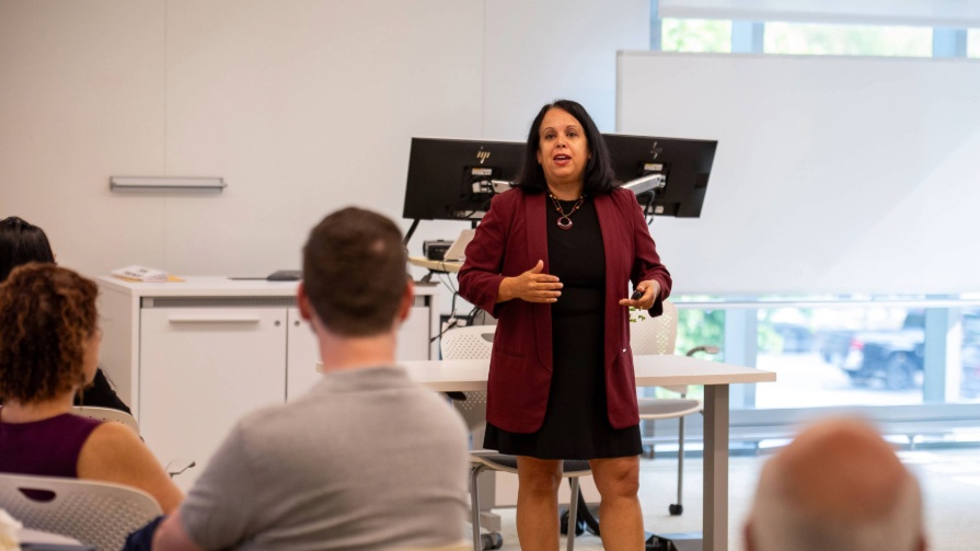 Dr. Kris Monahan, president of the National Council of University Research Administrators and director of sponsored projects and research compliance at Providence College, gives the keynote address at Bryant University's first Research Retreat.