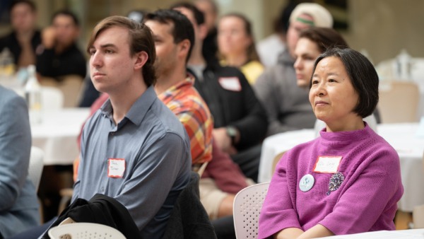 Attendees listen to speaker at Climate and Sustainability Earth Day Symposium.