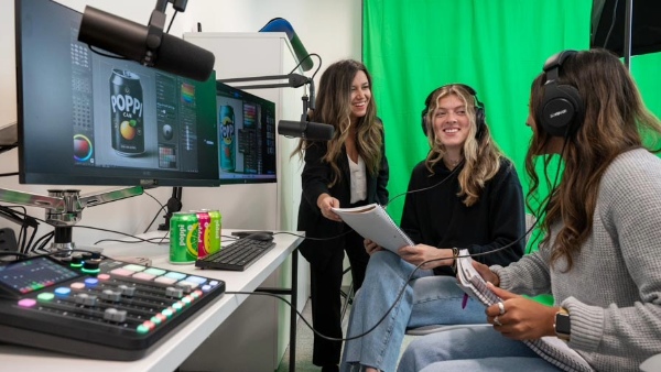 Students practice recording a podcast in Bryant's new Digital Marketing Lab.