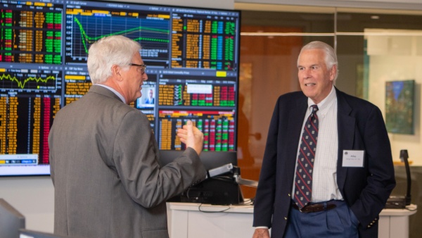 Professor and Chair of the Finance department Kevin Maloney, Ph.D., gives Michael E. Fisher ’67, ’15H a tour of the new Financial Markets Center.