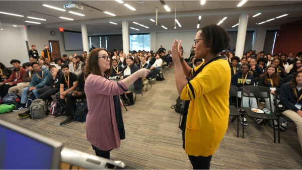 Theresa Hasseler, Ph.D., director of the Center for Teaching Excellence, and Veronica McComb, Ph.D., dean of the College of Arts and Sciences, lead a “Building Belonging” session of activities at Bryant University's Belonging Institute