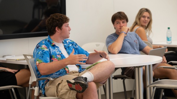 Student talking in classroom.