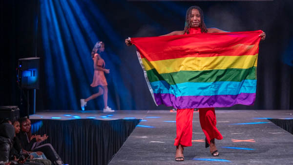 Student unfurls Pride flag at Extravaganza