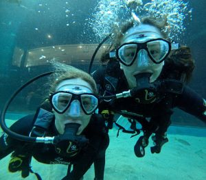 Two women scuba diving.