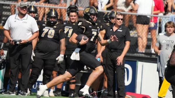 The Bryant football team engages in a spirited contest with the College of the Holy Cross. 