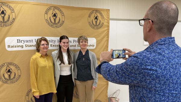 Julia Tricarico poses with faculty mentors after her Honors Program presentation