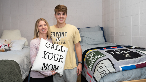 Son and mom in dorm room on move in day.