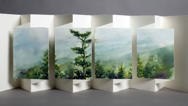 Book art scene of trees and mountains.