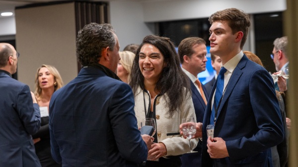 Bryant students Odette Mansour '24 and Brendan Fall's 24 network with Nico Santini '93