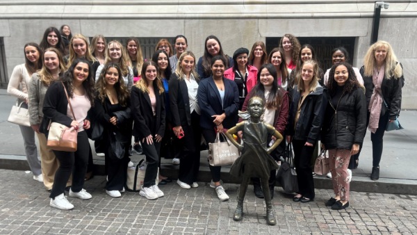 Bryant students pose with the famous "Fearless Girl" statue in New York City.