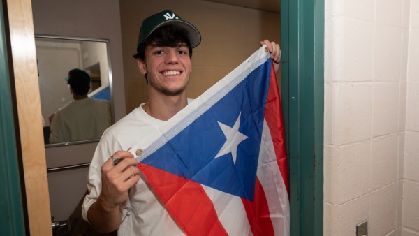 Students holds Puerto Rican flag.